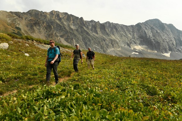 Hikers head down the trail from Capitol Lake with the massive Capitol Peak behind them on September 6, 2017, in the Maroon Bells-Snowmass Wilderness, Colorado. (Photo by Helen H. Richardson/The Denver Post)